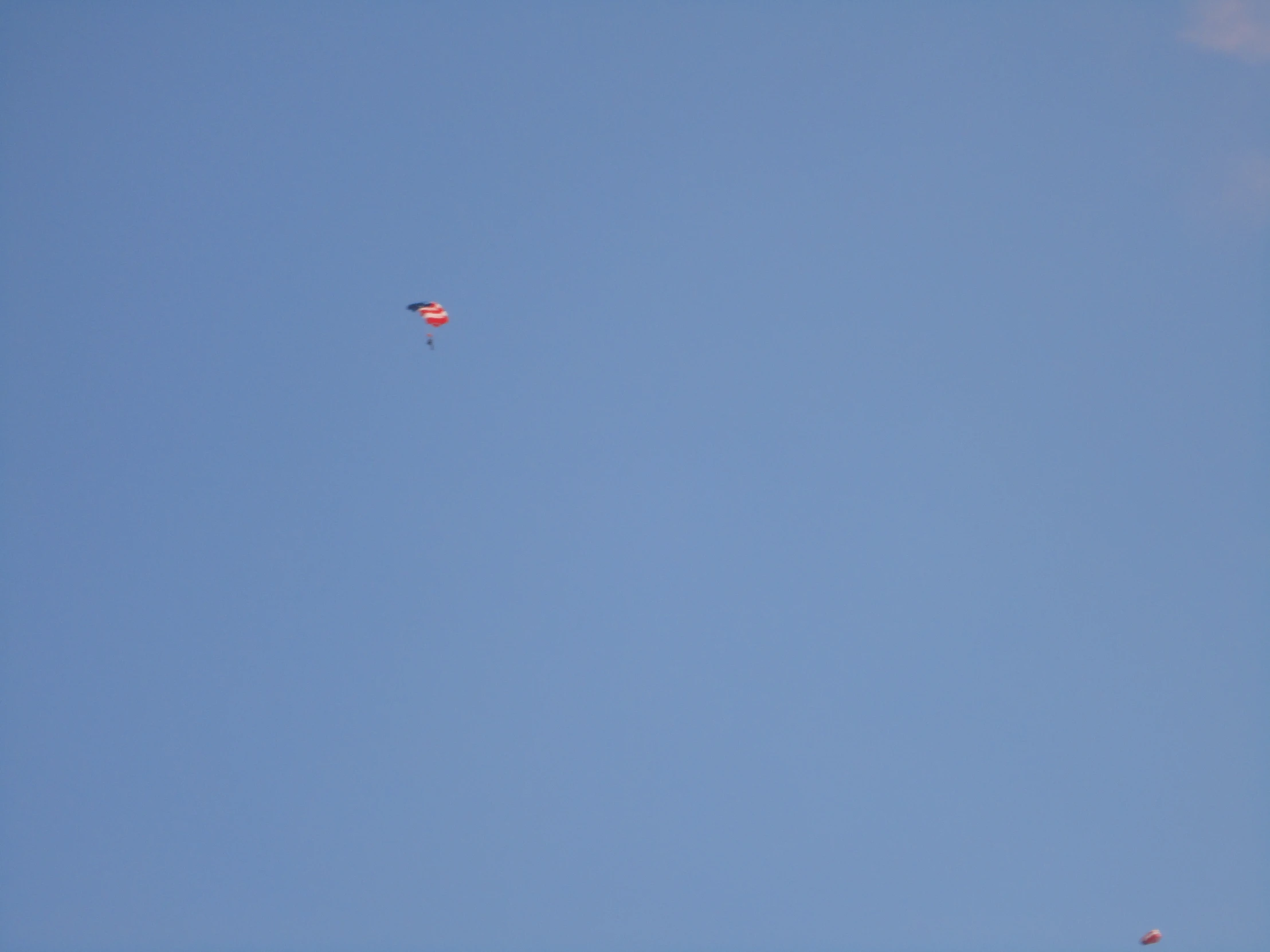 two kites flying against the clear blue sky