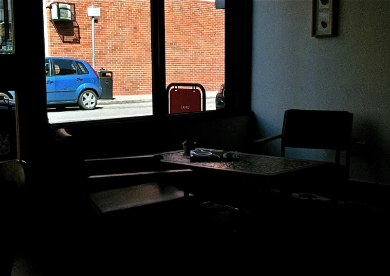 a window view shows cars on the street