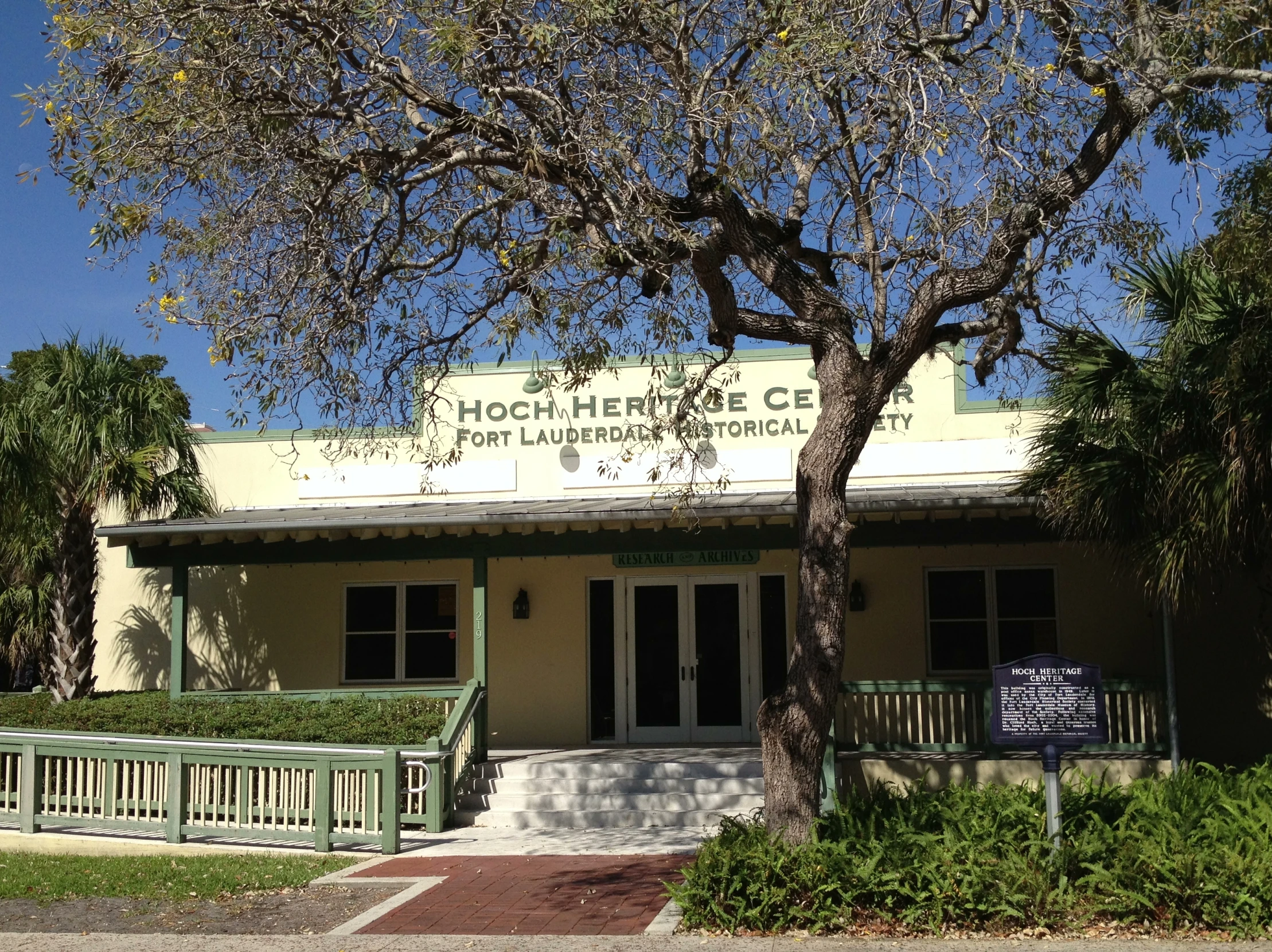 front of building on sunny day near a tree