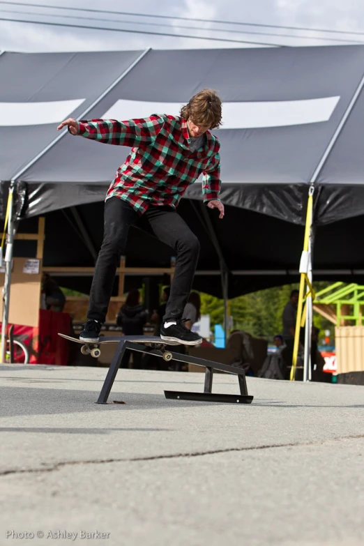a boy skateboarding on a ramp at a skate park