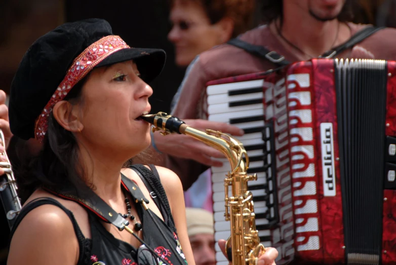 a person playing on a saxophone and an accordion