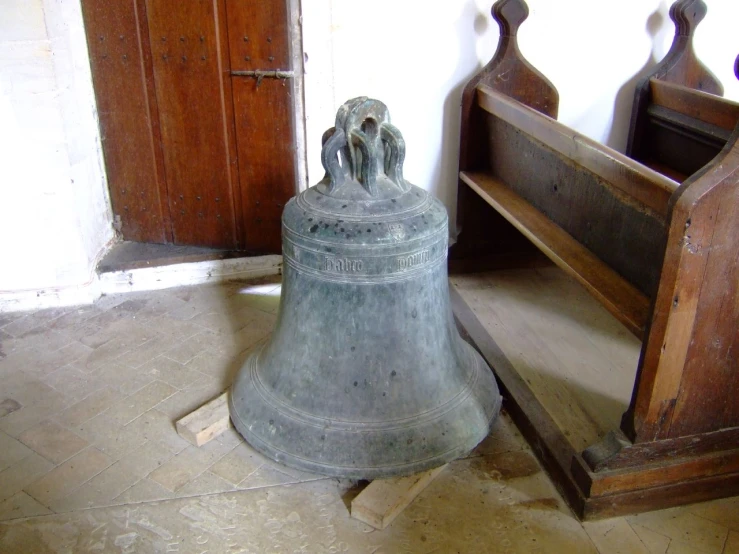 an old style bell on display with another near it