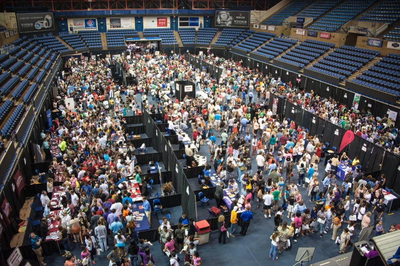 a group of people are standing inside the stadium