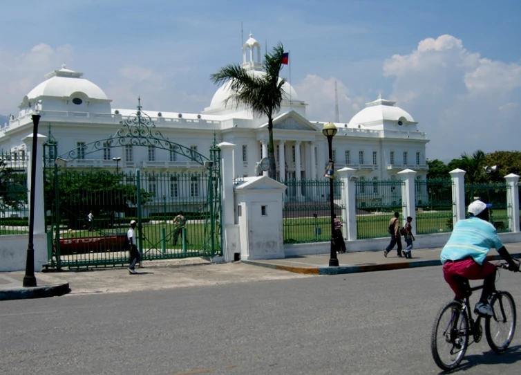 a woman is riding a bike in front of a building