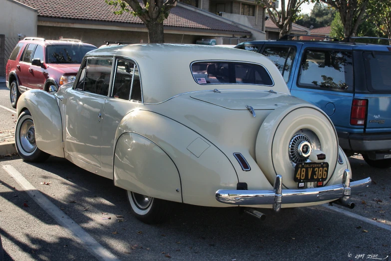 an old car parked next to a house