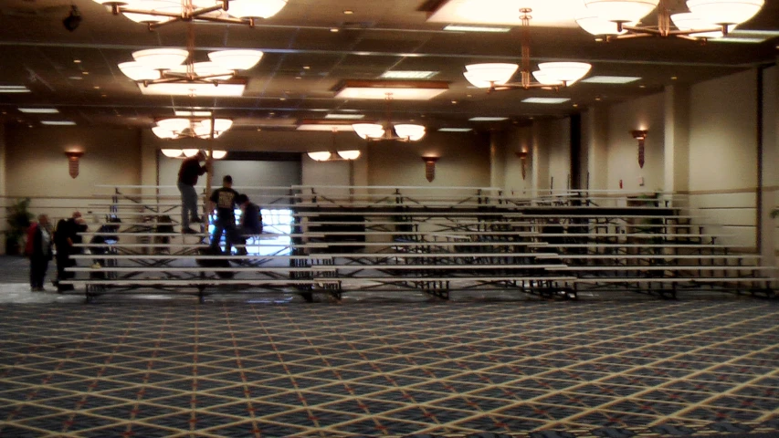 an empty ballroom with many seating areas and tables