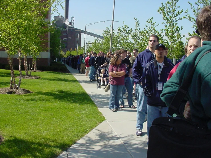 a group of people are walking down a sidewalk