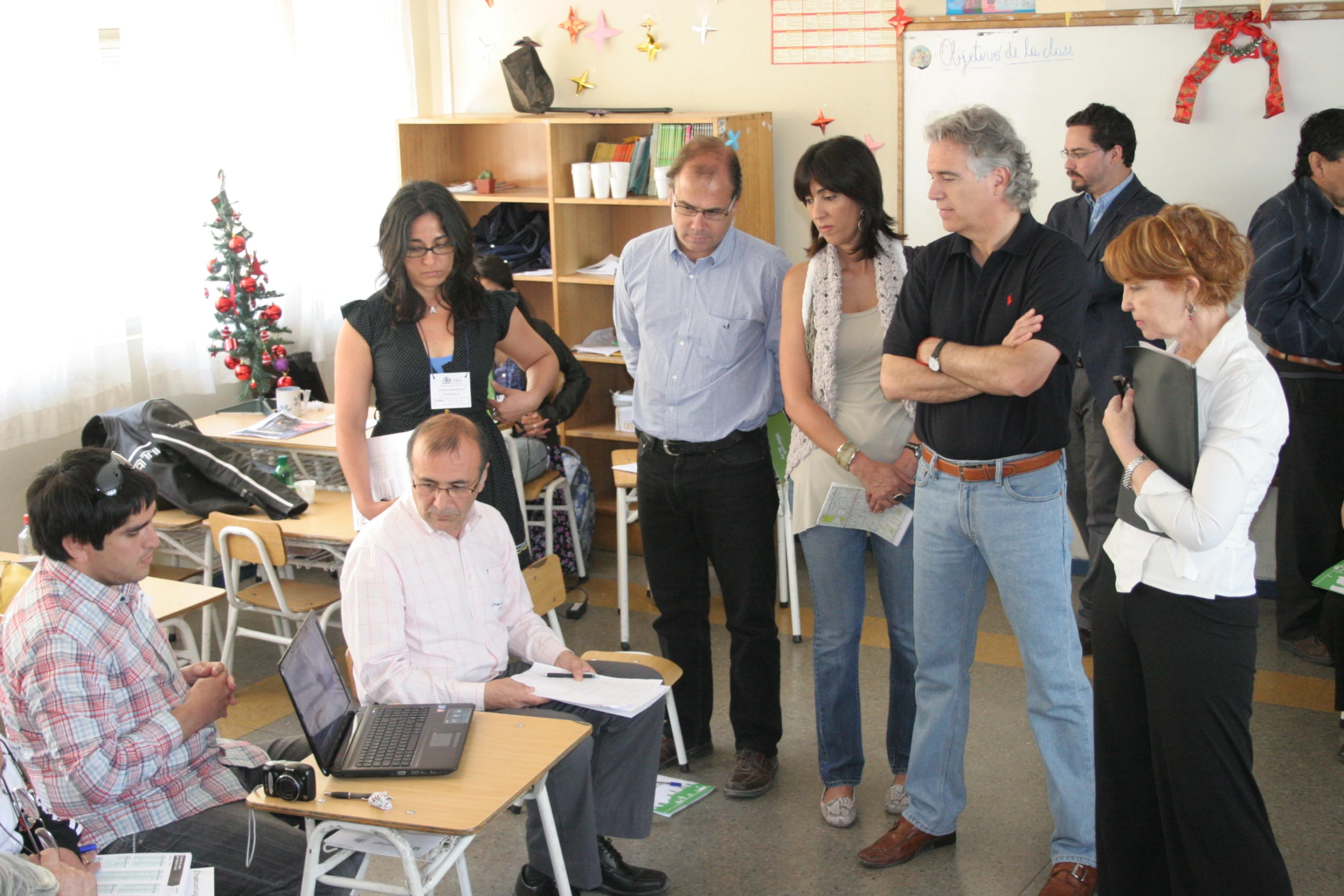 a group of people stand around in a room