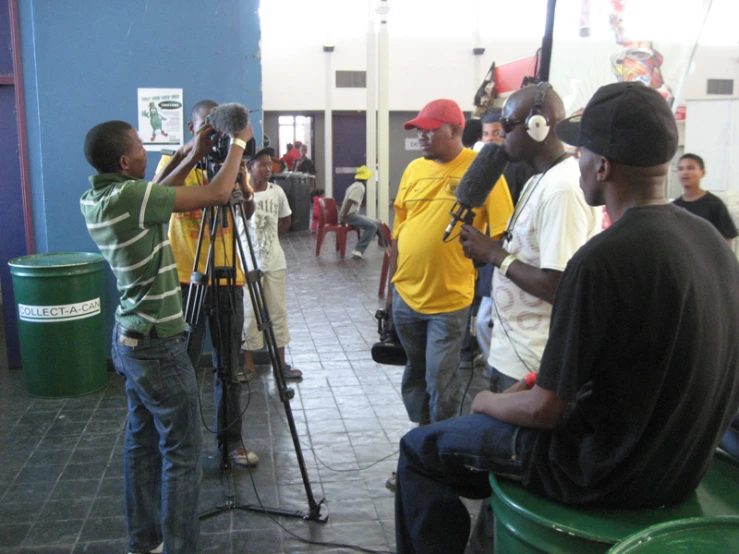 two men looking at another man behind the camera