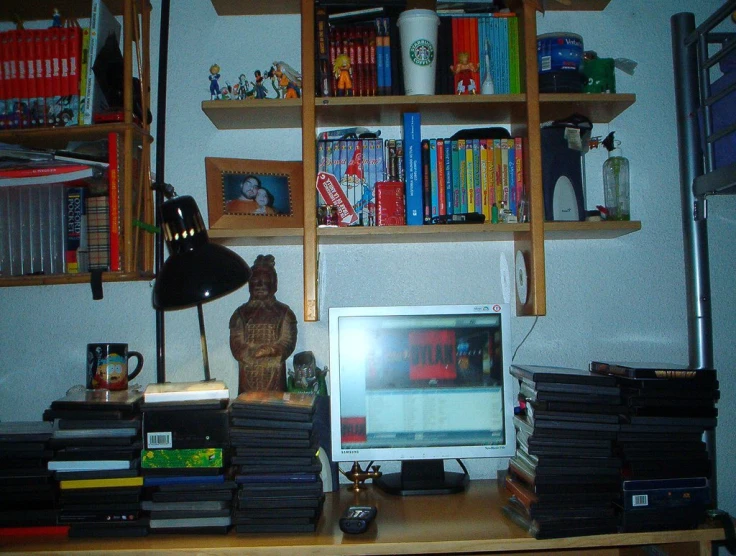 a computer monitor and keyboard sitting on a desk in front of a computer
