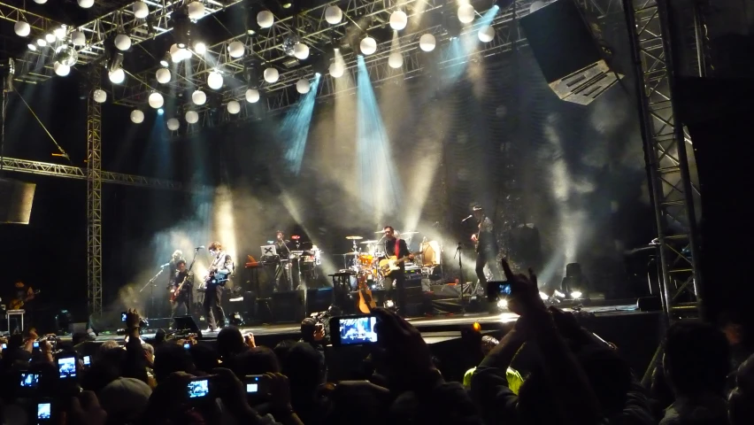 a group of people on stage with their cell phones