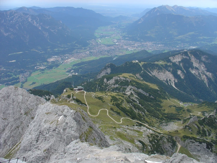 view from the top of mountain looking at roadway curves