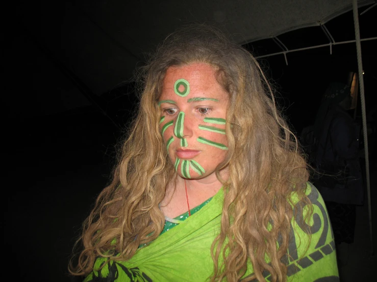 a woman with long hair has painted on her face