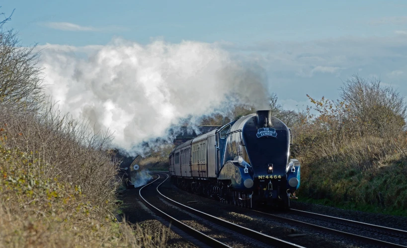 train on the tracks with smoke coming from it