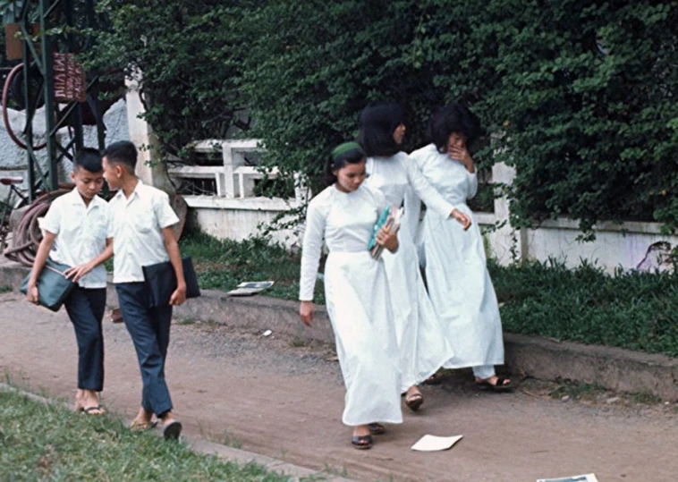 a group of people walking along a road