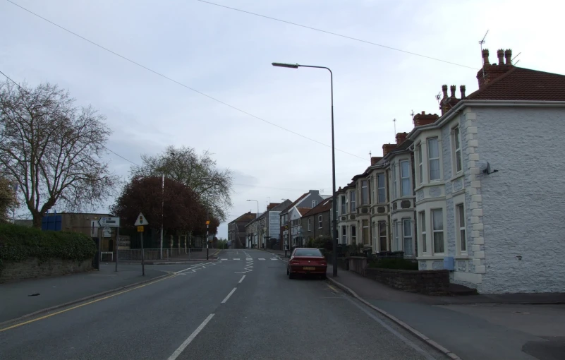 a car is parked at the end of a quiet street