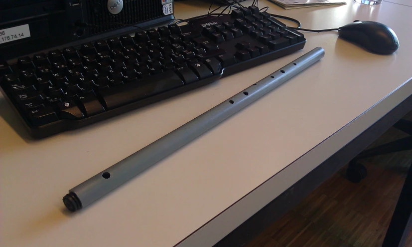 a pen sits next to a keyboard on the desk