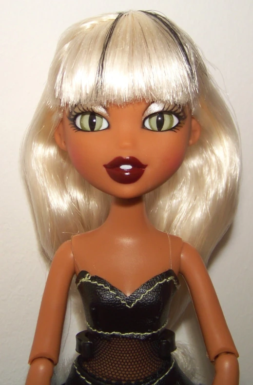 a female doll with blond hair and a dress