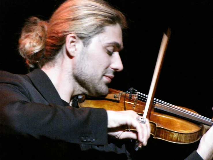 a man playing an instrument with one hand