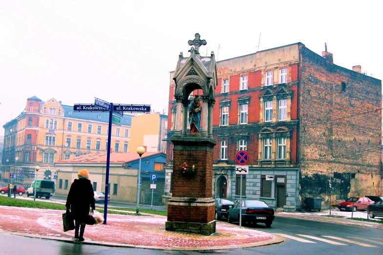 the old clock is on top of the building in the middle of the road