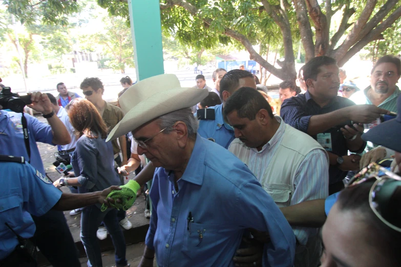 a man is holding up a green apple