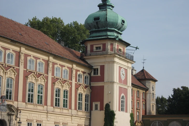 a very tall building with a big green dome on top