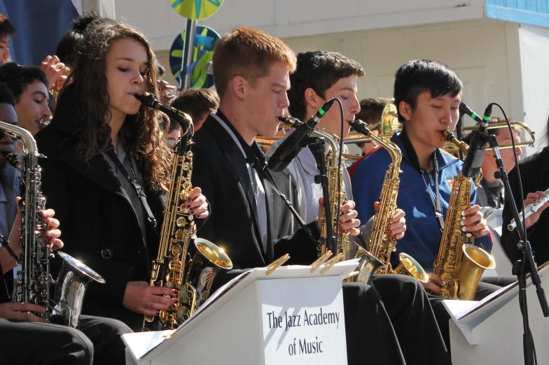 the young musicians are playing the music on their instruments