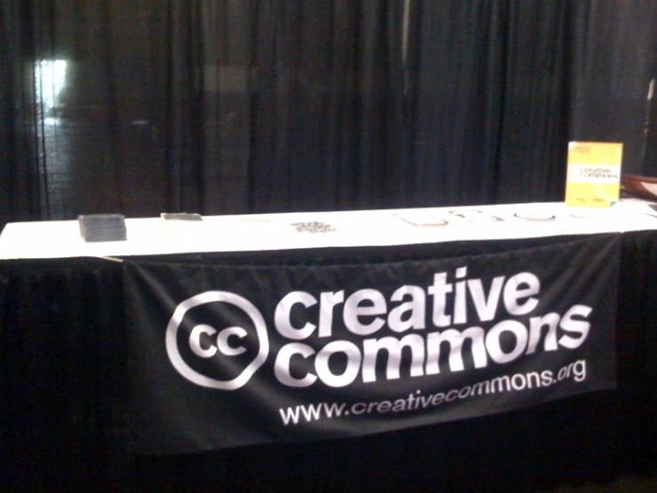 a table with an exhibit sign and a white table cloth