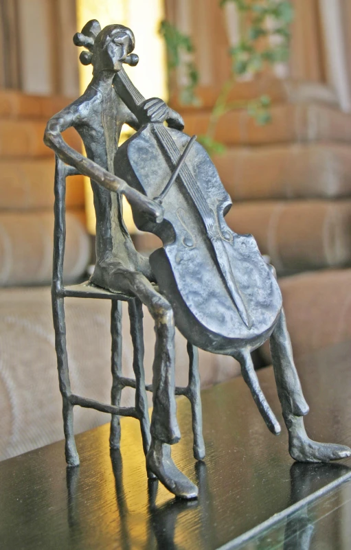 a metal sculpture of a man playing a violin