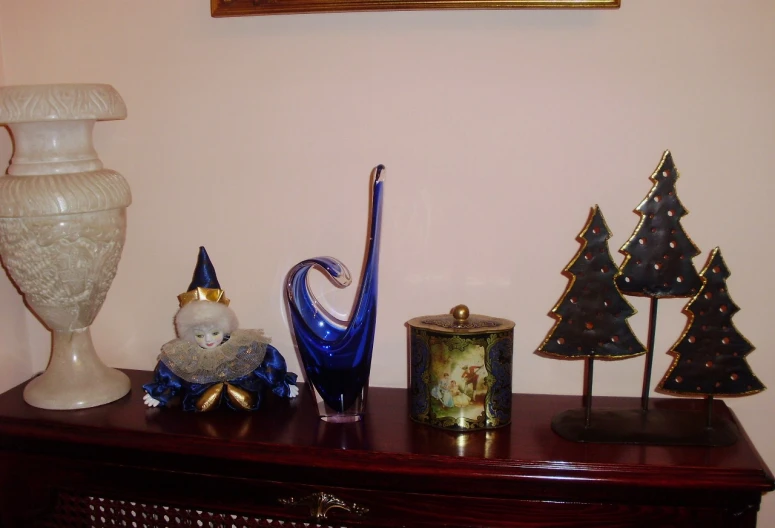 an ornate wooden cabinet displays blue ornaments and a fountain