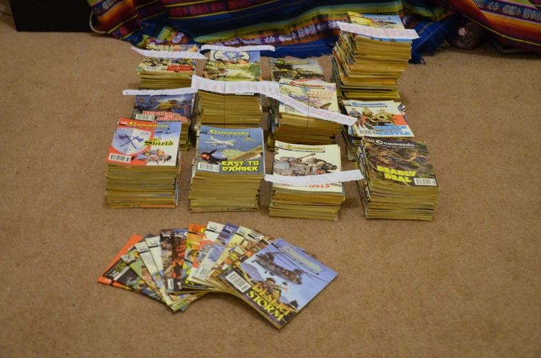 many books are sitting on the floor with tags attached