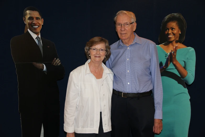 three people are posing for a po with barack obama behind them