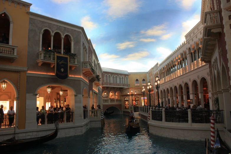 boats and people in a waterway at an indoor mall