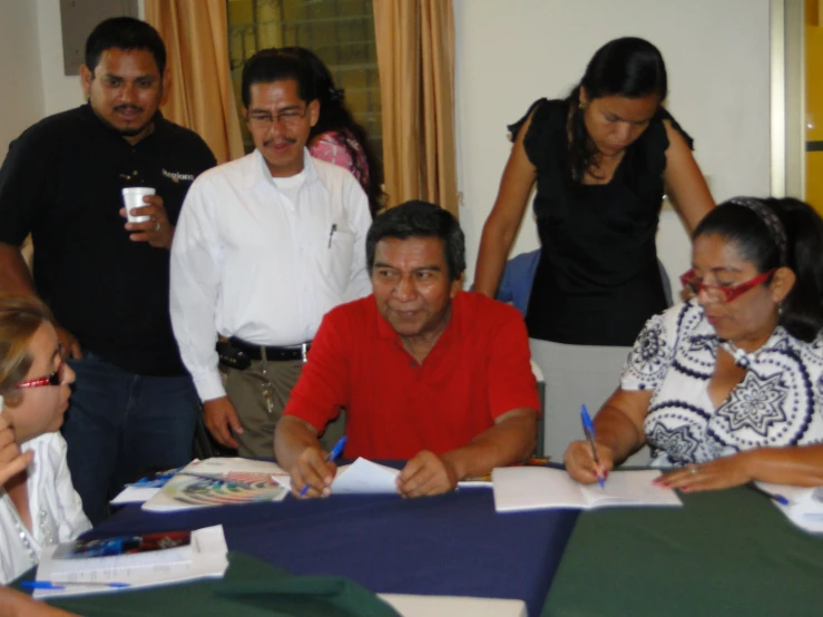 the man and women are signing documents and talking