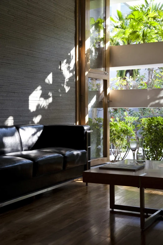 a living room has black couches and a brown coffee table