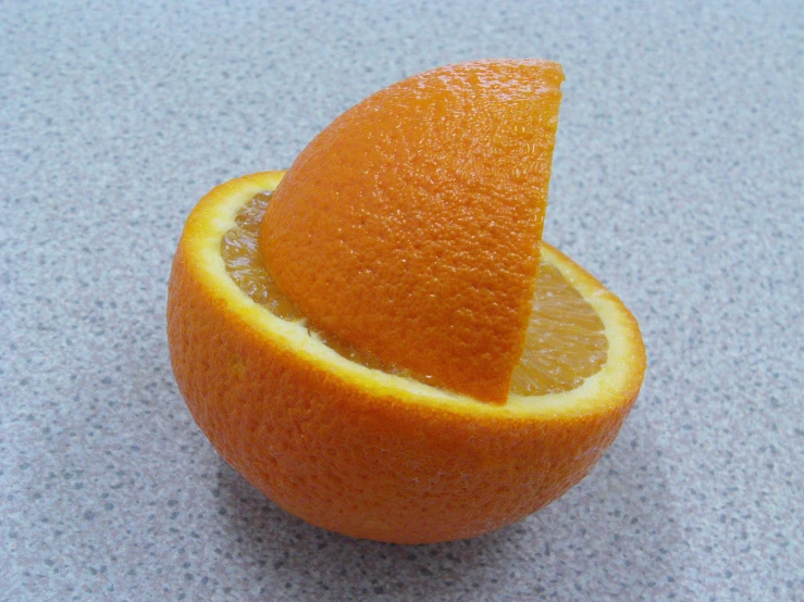 an orange with a wedge cut out of it