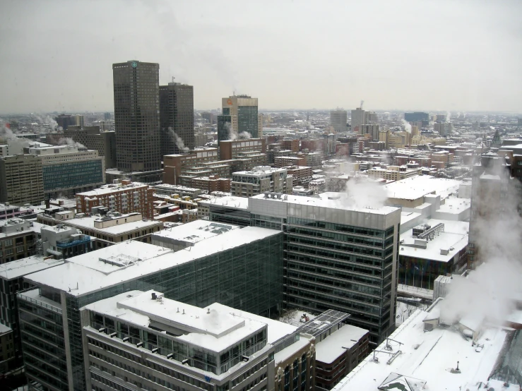 the city with snow in the foreground and high rise buildings on the right