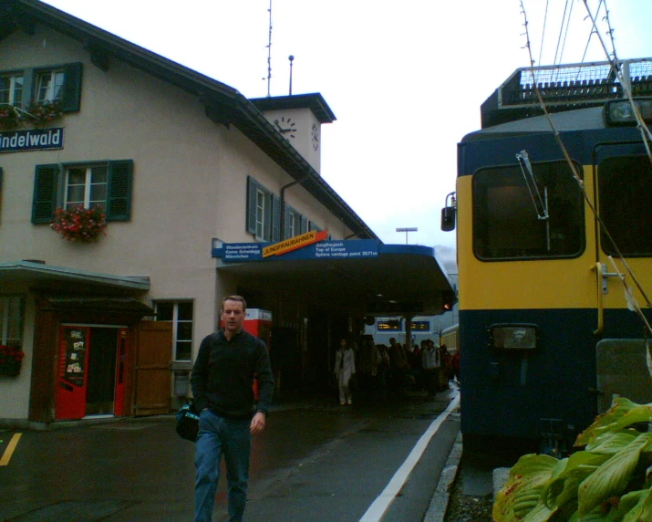 a man is walking away from a train station