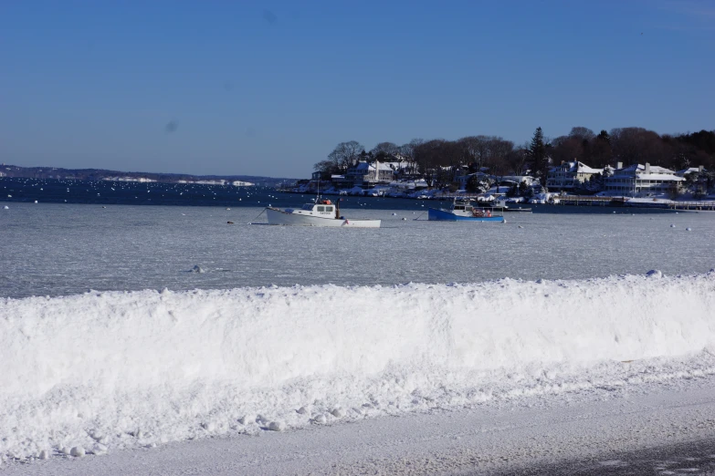 a beach that has a boat and water in it