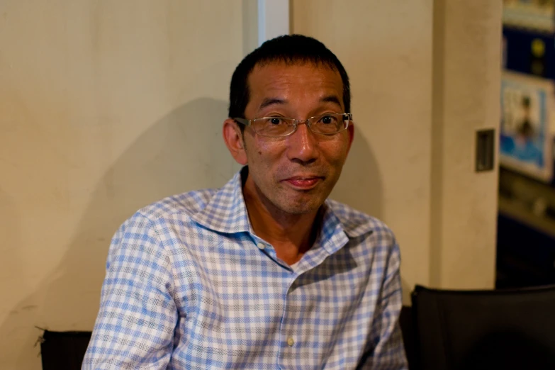 a man in glasses and a white shirt with a beard