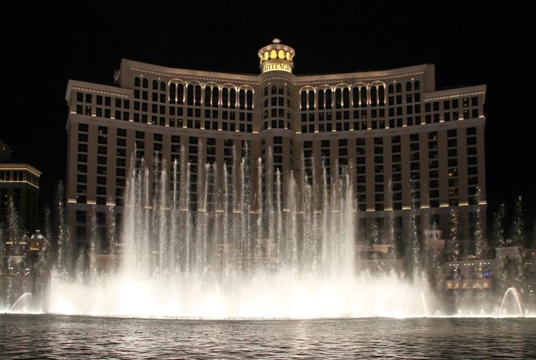 a large fountain is in front of the building