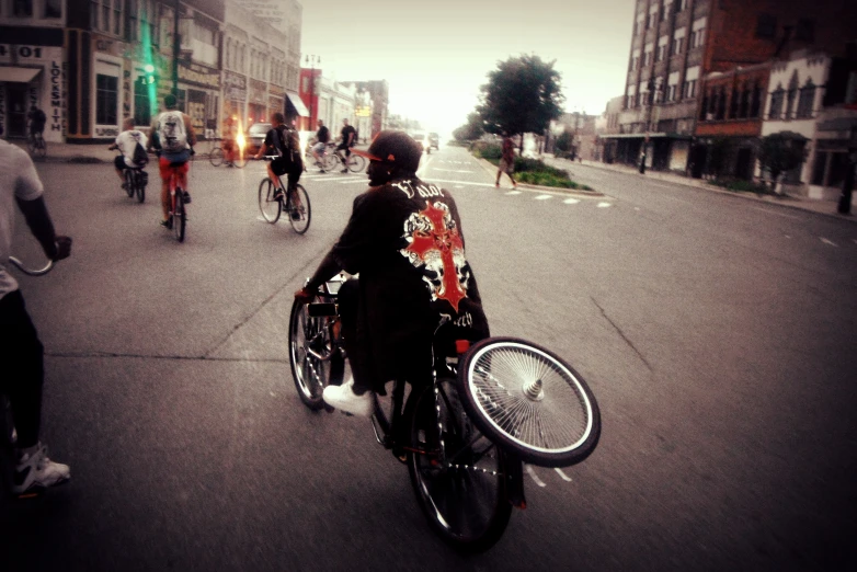 people riding bikes on a street during the day