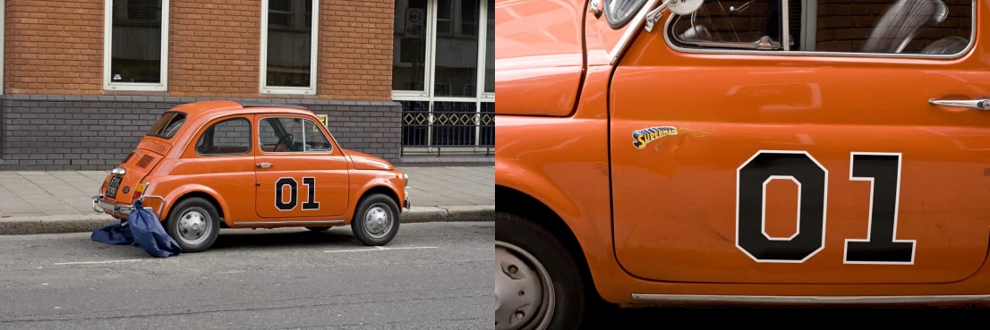 an orange vintage car and blue bag sitting on the curb