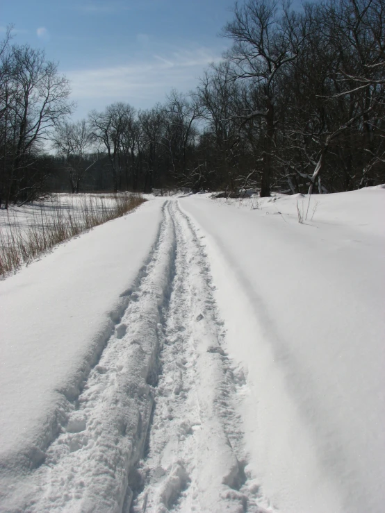 the snow is on the road and it appears to be very deep