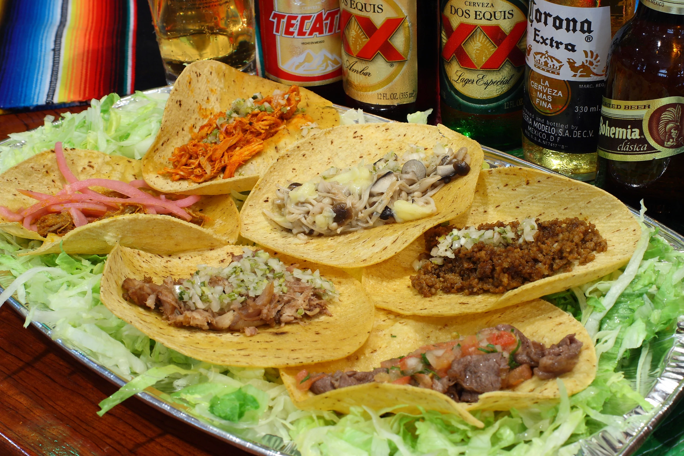 mexican food is arranged on the serving tray