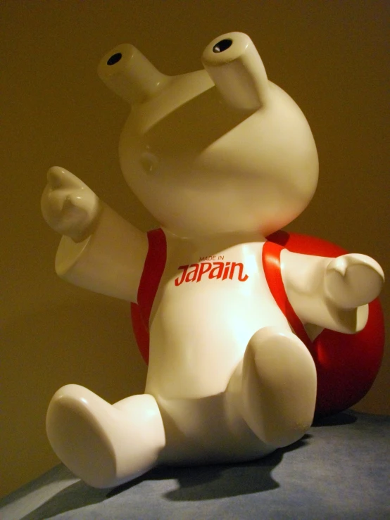 a white elephant figurine sitting on a bed