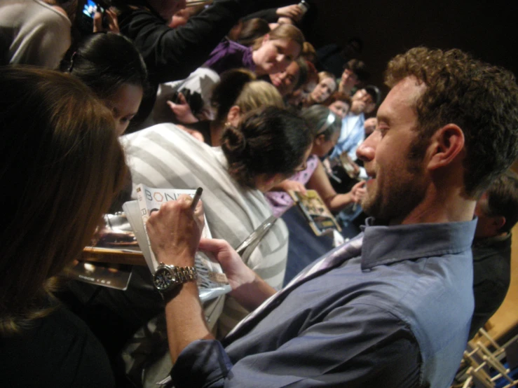 a man holding a smart phone up to a woman's ear