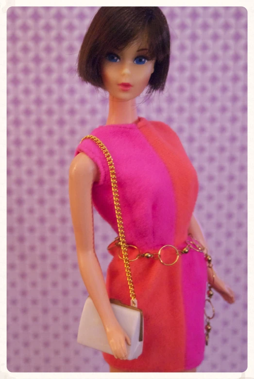 a barbie doll with a red dress holding a white purse