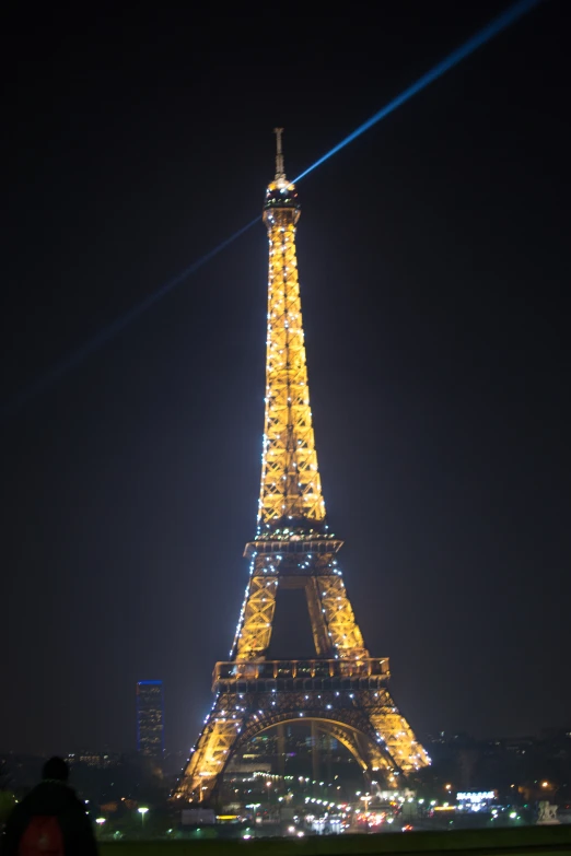 the eiffel tower is illuminated with lights in paris