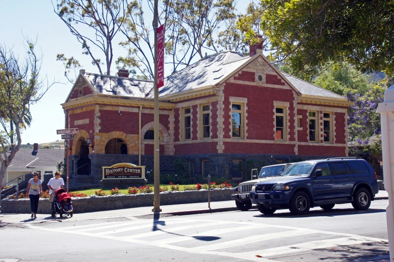 the house is surrounded by several trees in the town square